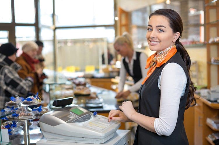 Image representing Smart Safe benefits for retailers, showing restaurant employee using cash register